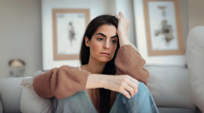 Woman struggling with overthinking during psychotherapy session at Existence Clinics.