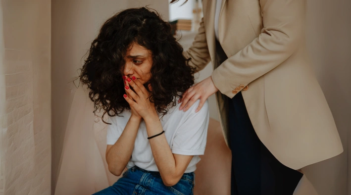 Therapist helping woman process trauma and emotional pain at Existence Clinics.