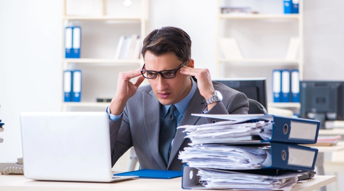 Man stressed at work receiving workplace counseling to manage pressure at Existence Clinics.